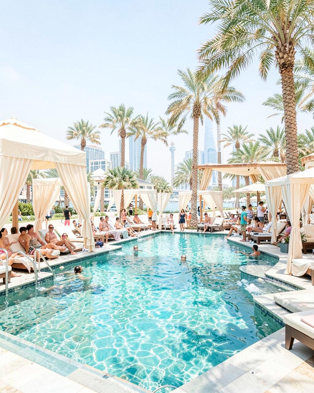 Luxury pool and beach club celebration in Dubai with ivory cabanas